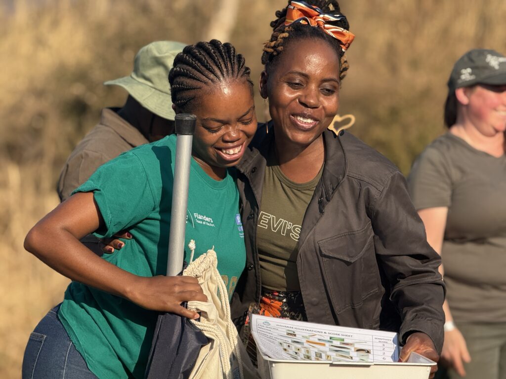 Volunteers in South Africa at a citizen science training. A trainee in Zimbabwe practices a water measurement method. Photo: Nkateko Langa/ IWMI